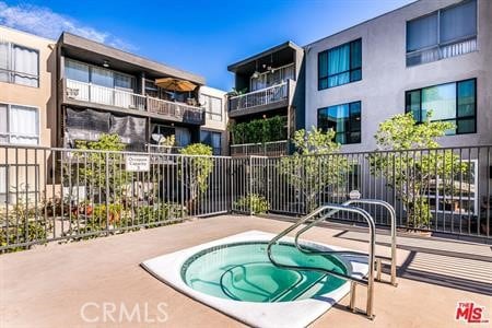 view of pool with a community hot tub and a patio area