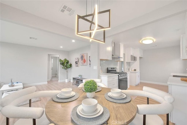 dining space featuring light wood-type flooring