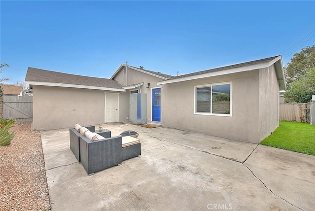 back of property with outdoor lounge area and a patio