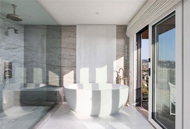 bathroom with shower with separate bathtub, tile walls, and a wealth of natural light