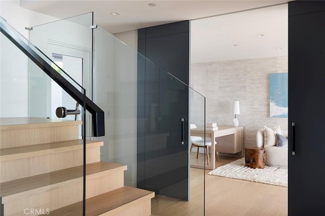 stairs featuring hardwood / wood-style flooring