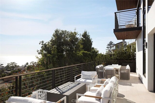 view of patio / terrace with a balcony and an outdoor living space