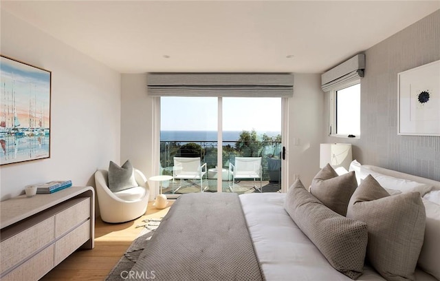 bedroom featuring access to exterior and light hardwood / wood-style flooring