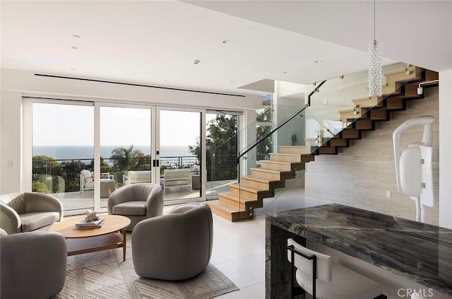 interior space featuring a water view and light tile patterned floors