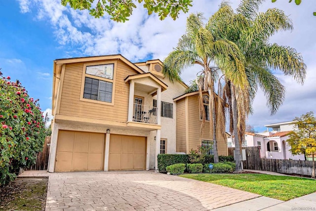 view of front of property with a balcony and a garage