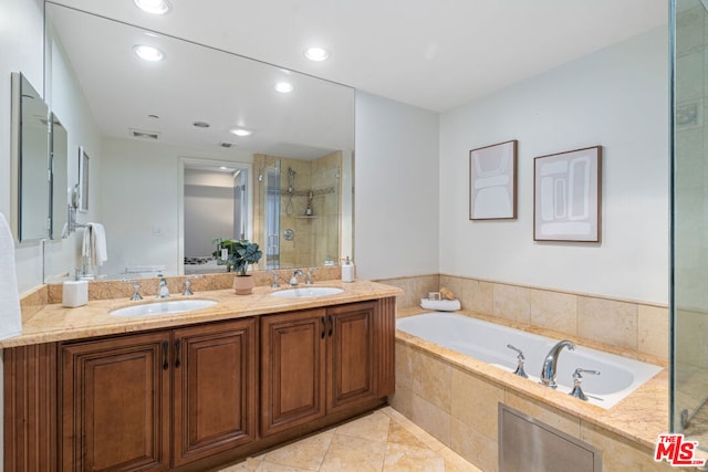 bathroom featuring vanity, tile patterned floors, and independent shower and bath