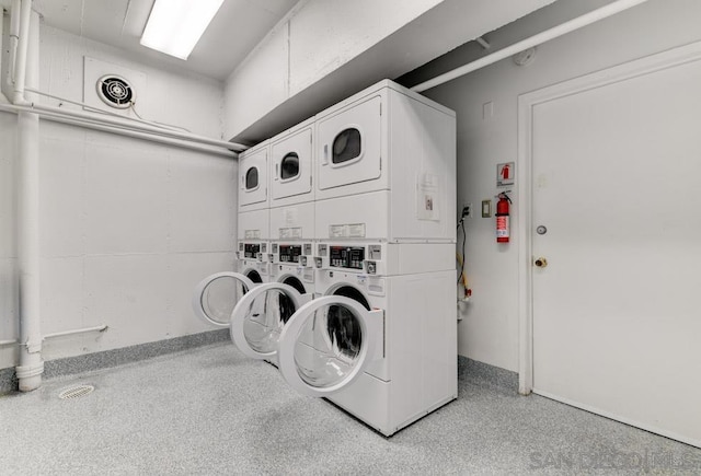 laundry area featuring stacked washer and clothes dryer and independent washer and dryer