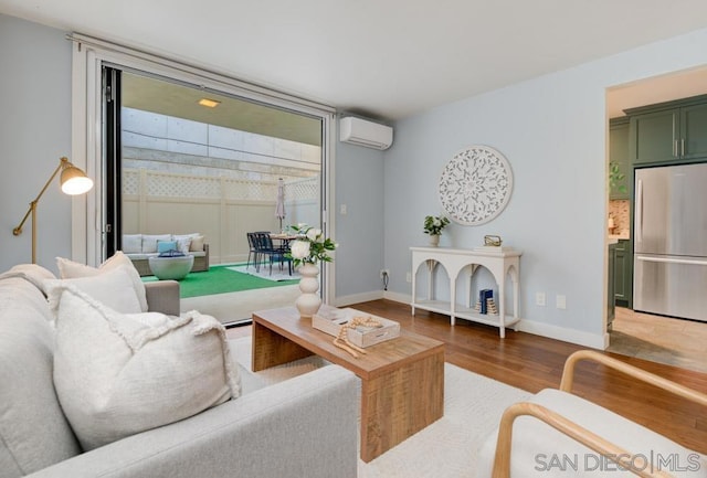 living room with hardwood / wood-style floors and a wall mounted AC