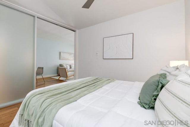 bedroom with ceiling fan, hardwood / wood-style floors, and a closet