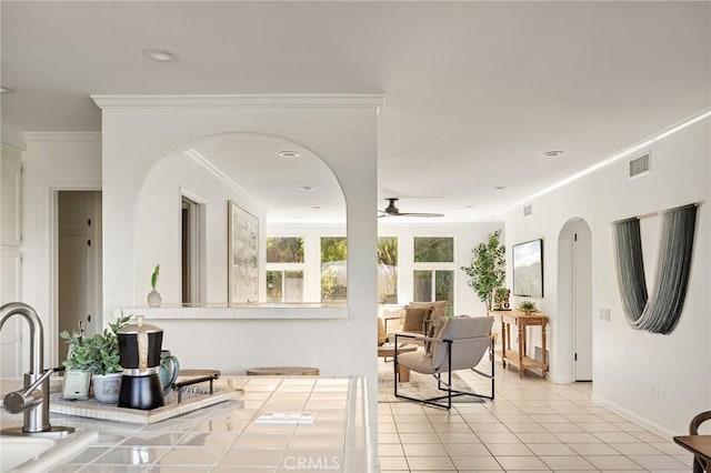 interior space featuring crown molding and ceiling fan