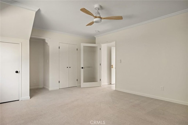 unfurnished bedroom with crown molding, light carpet, and ceiling fan