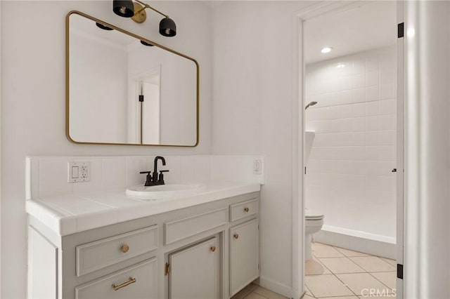 bathroom featuring vanity, tile patterned floors, toilet, and a shower