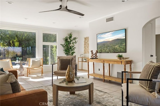 living area featuring light tile patterned floors and ceiling fan