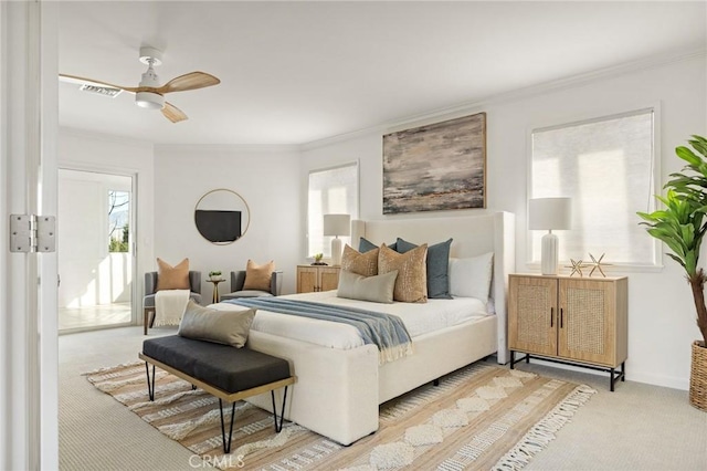 carpeted bedroom featuring ornamental molding and ceiling fan