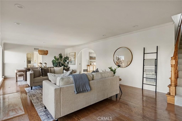 living room with ornamental molding and dark hardwood / wood-style flooring