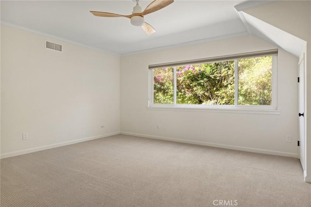 unfurnished room featuring light carpet, crown molding, a wealth of natural light, and ceiling fan