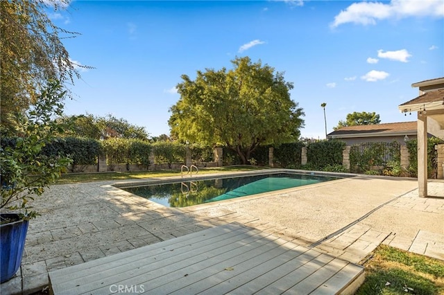 view of swimming pool with a patio area