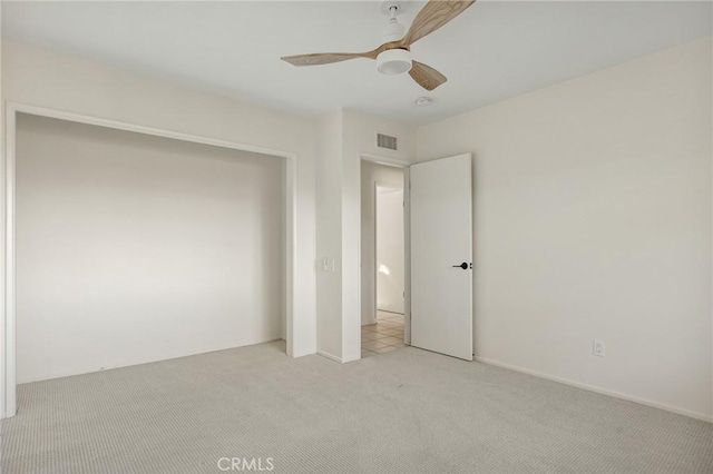 unfurnished bedroom featuring light carpet and ceiling fan