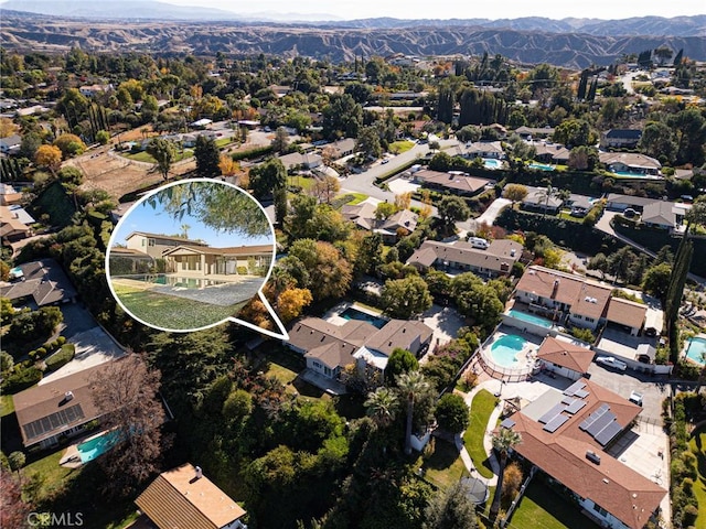 birds eye view of property featuring a mountain view