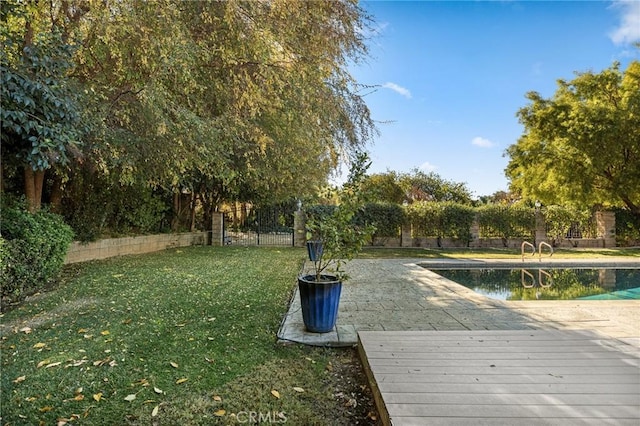 view of yard featuring a pool side deck with water view