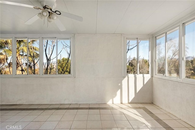 unfurnished sunroom with ceiling fan