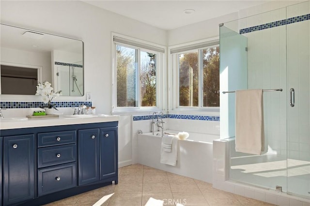 bathroom featuring tasteful backsplash, plus walk in shower, tile patterned floors, and vanity