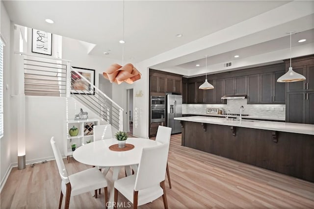 dining space featuring sink and light hardwood / wood-style flooring