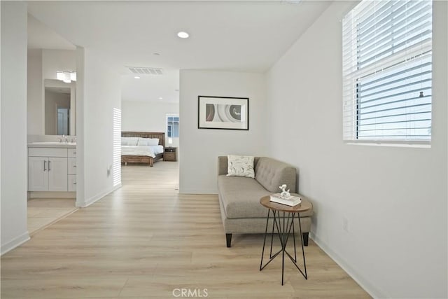 sitting room featuring sink and light hardwood / wood-style flooring