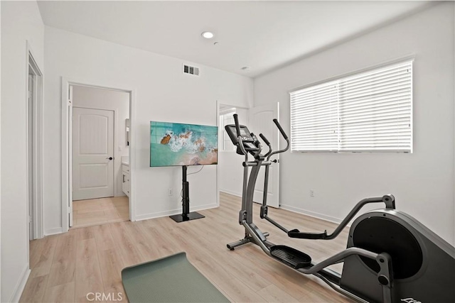 exercise room with light wood-type flooring