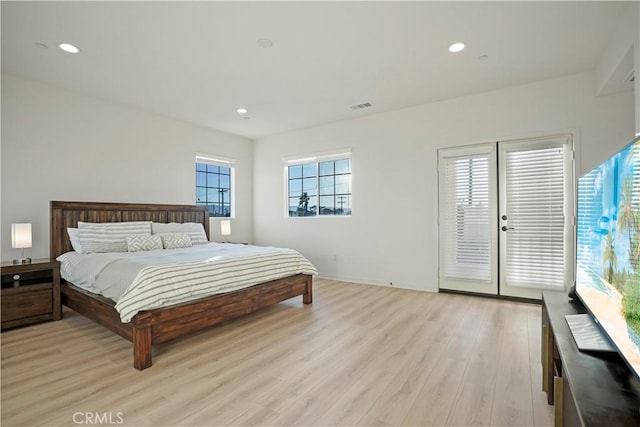 bedroom featuring access to exterior and light hardwood / wood-style floors