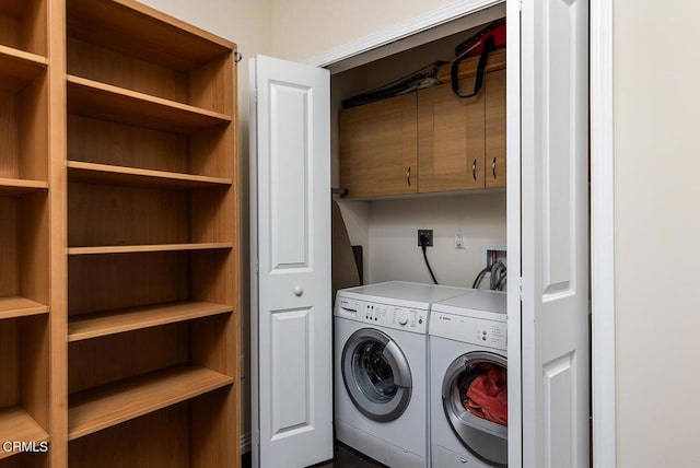 laundry area with cabinets and washing machine and clothes dryer