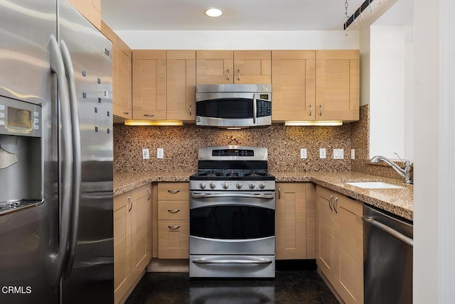 kitchen with light brown cabinetry, sink, stainless steel appliances, and light stone countertops