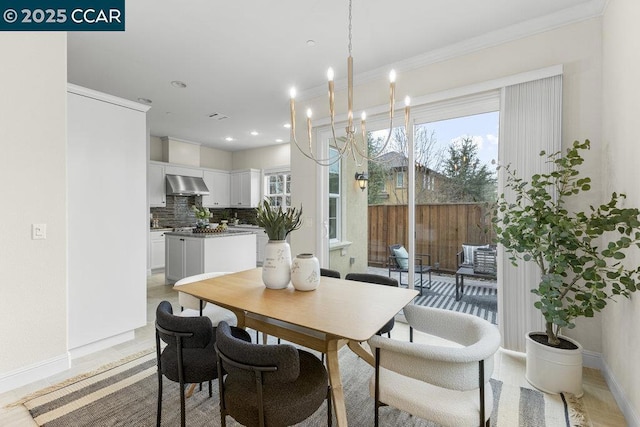 dining space featuring an inviting chandelier, crown molding, and a wealth of natural light