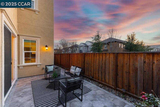 patio terrace at dusk featuring outdoor lounge area