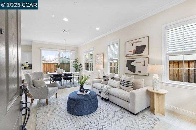 living room featuring crown molding and a chandelier