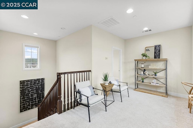 living area featuring light colored carpet