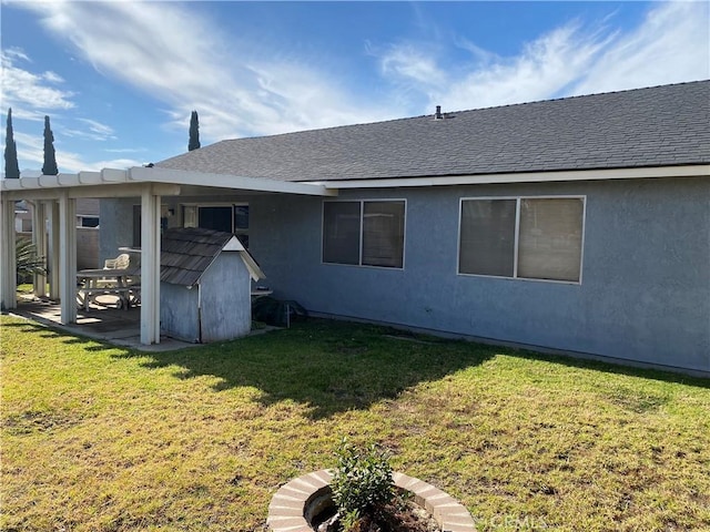 back of property featuring a lawn and a patio