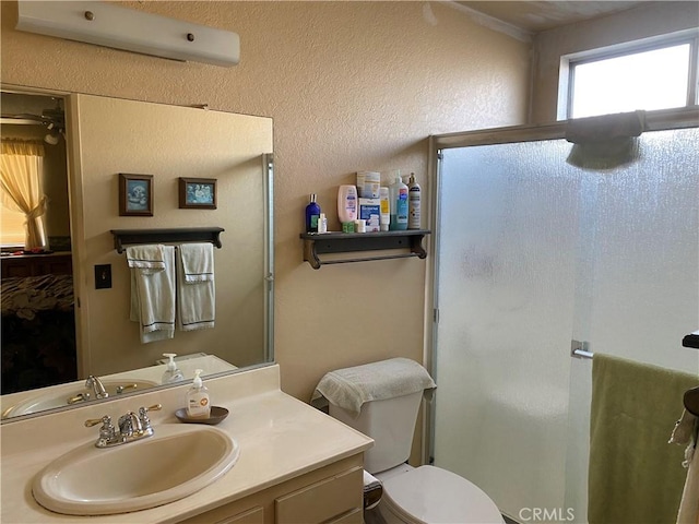 bathroom featuring vanity, toilet, a shower with door, and an AC wall unit