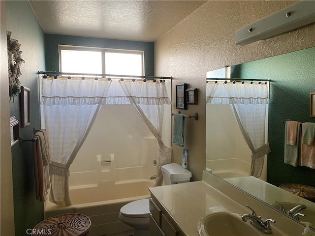 full bathroom featuring vanity, toilet, a textured ceiling, and shower / bathtub combination with curtain