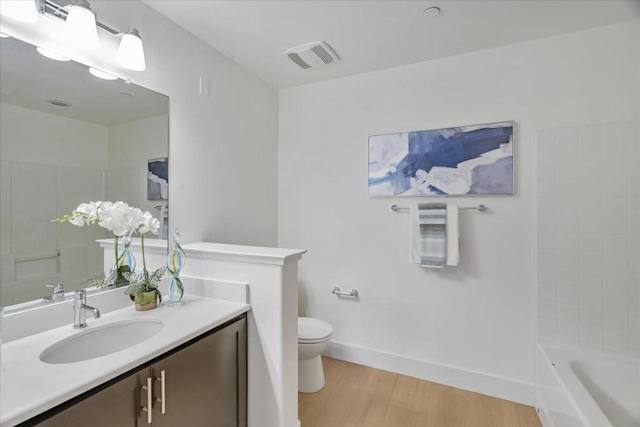 bathroom featuring vanity, hardwood / wood-style flooring, and toilet