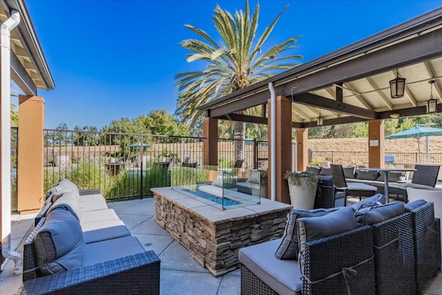 view of patio with a gazebo and an outdoor living space with a fire pit