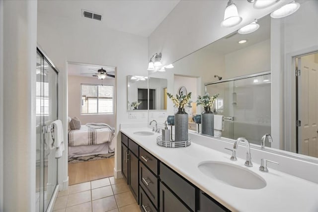 bathroom featuring a shower with door, vanity, tile patterned floors, and ceiling fan