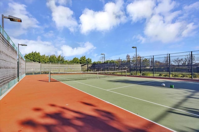 view of tennis court with basketball hoop