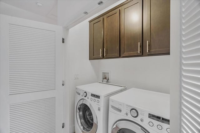 laundry room featuring cabinets and washer and clothes dryer