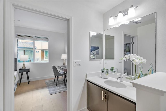 bathroom featuring vanity and hardwood / wood-style floors