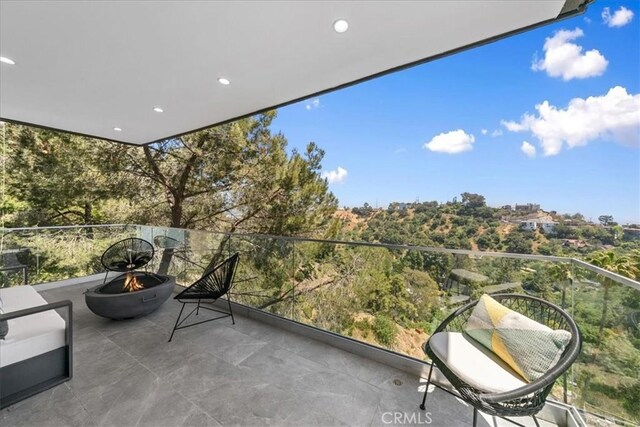 balcony featuring an outdoor fire pit