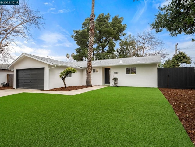 ranch-style home with a garage and a front lawn