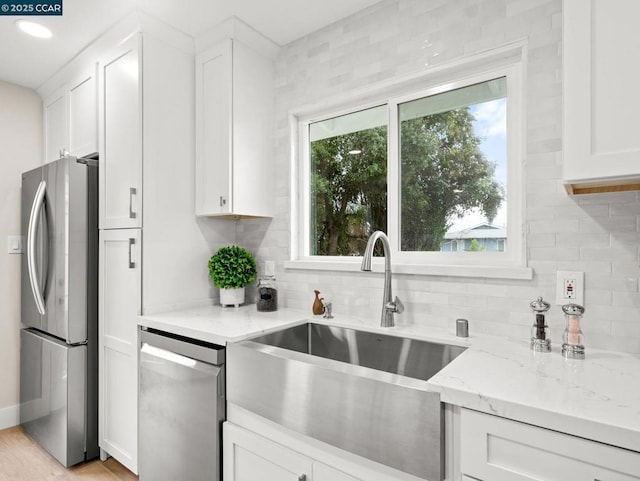 kitchen with sink, white cabinets, and appliances with stainless steel finishes