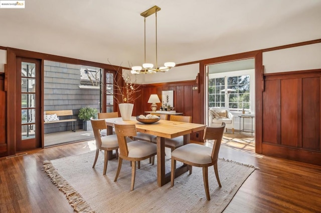 dining area featuring an inviting chandelier and wood-type flooring