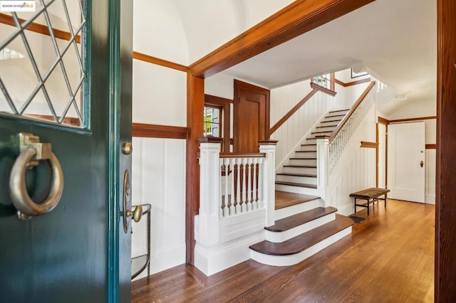 stairs featuring hardwood / wood-style floors